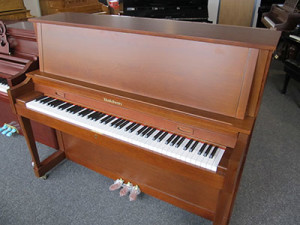 Baldwin model B-47 studio upright piano with American walnut finish